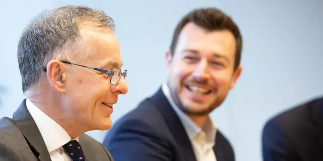 Two smiling businessmen in conversation